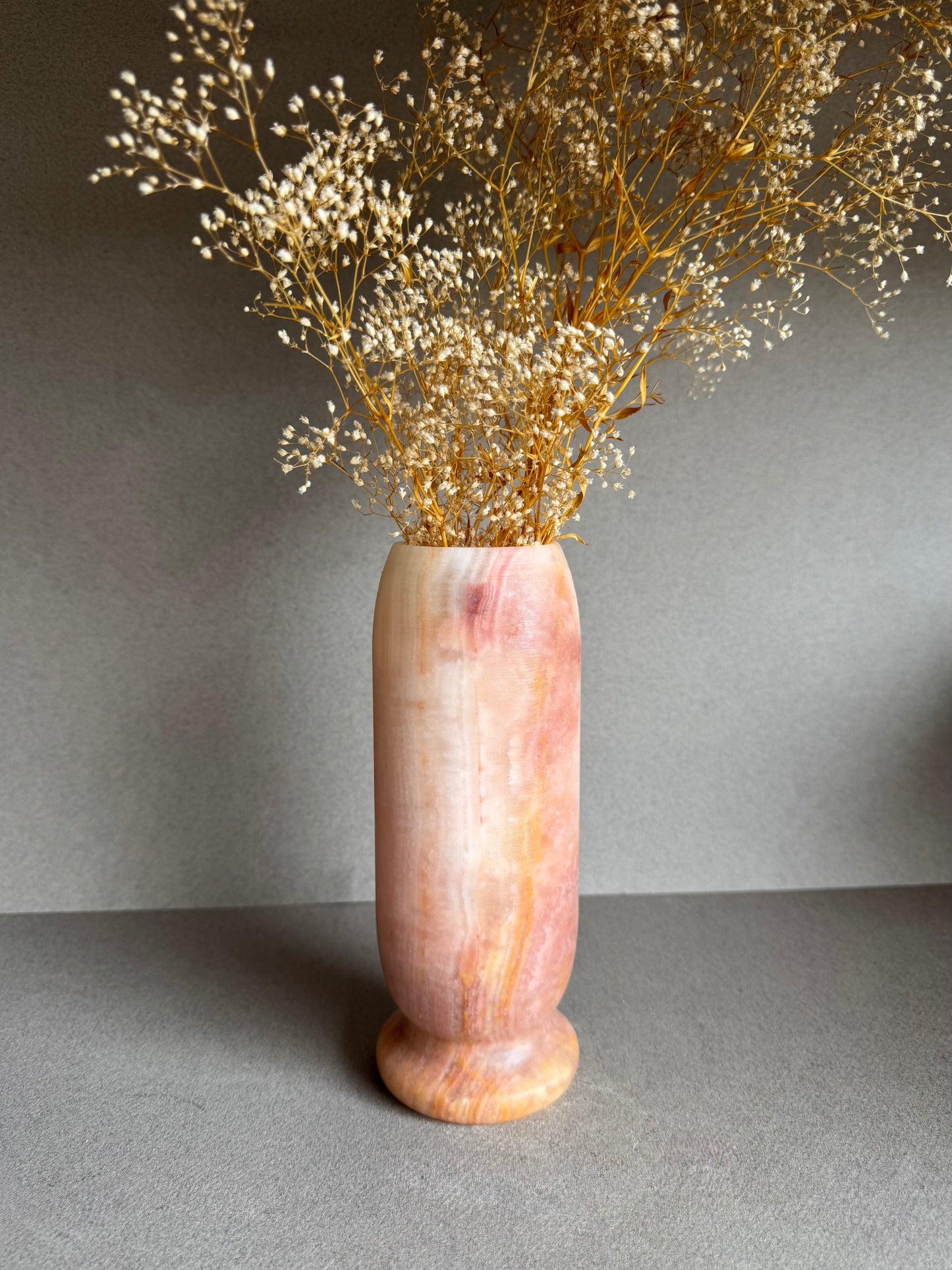 Angled floral-styled shot showing sculptural silhouette and mineral depth.

