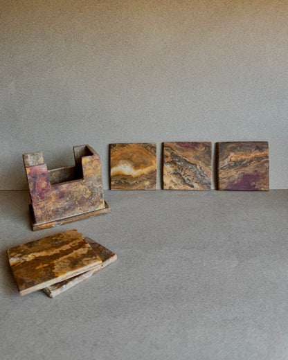 Coaster set with holder and coasters arranged upright, displaying the variation in onyx tones

