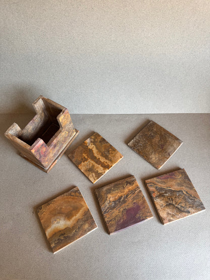 Coaster set with holder and coasters arranged upright, displaying the variation in onyx tones

