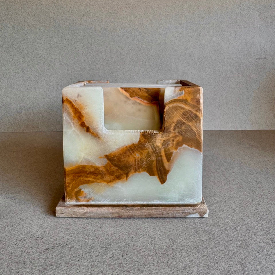 Front view of hand-carved onyx coaster holder in cream, caramel, and honey tones

