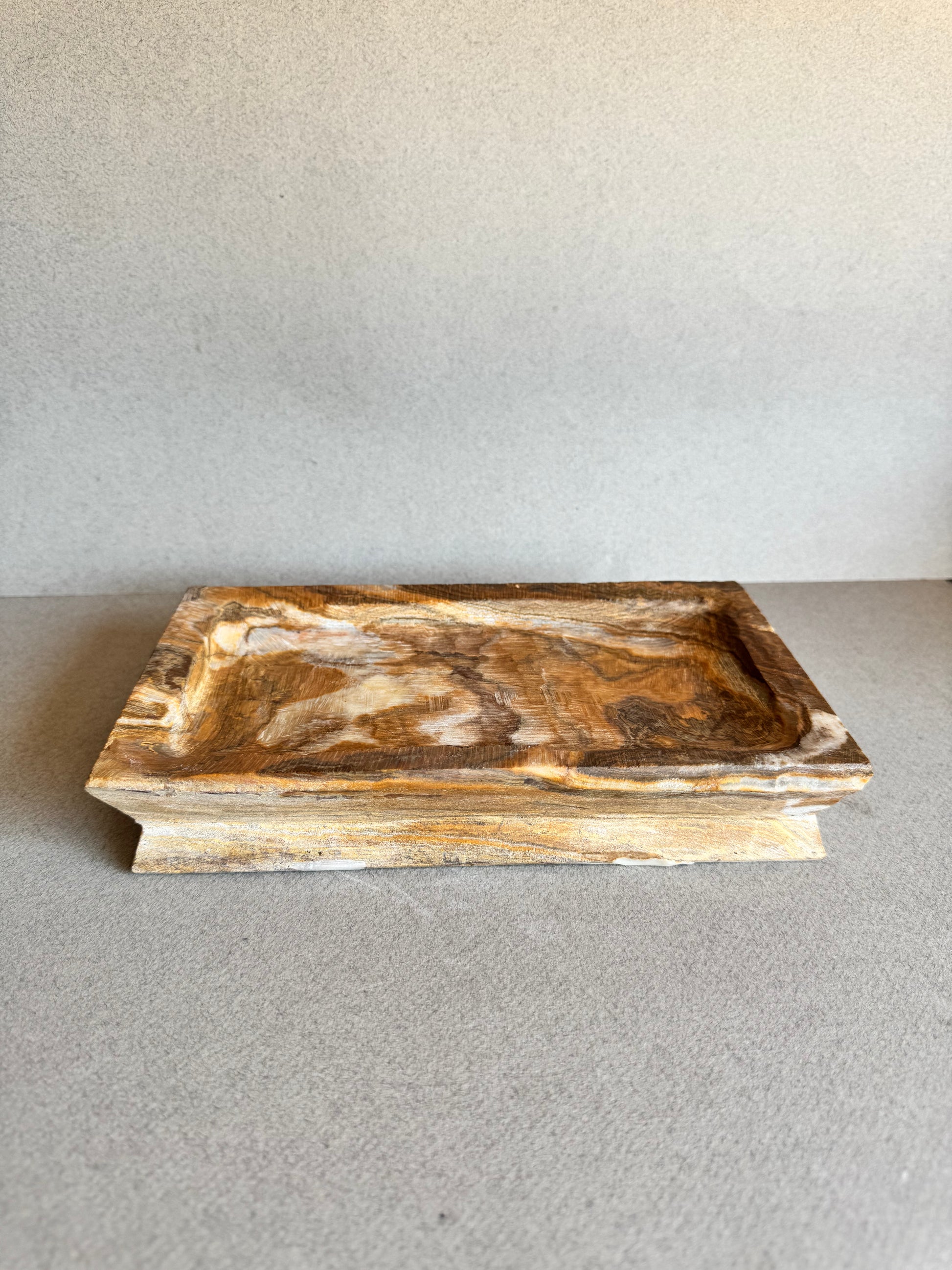 Rectangular tray in warm amber onyx, shown empty from a front-facing view


