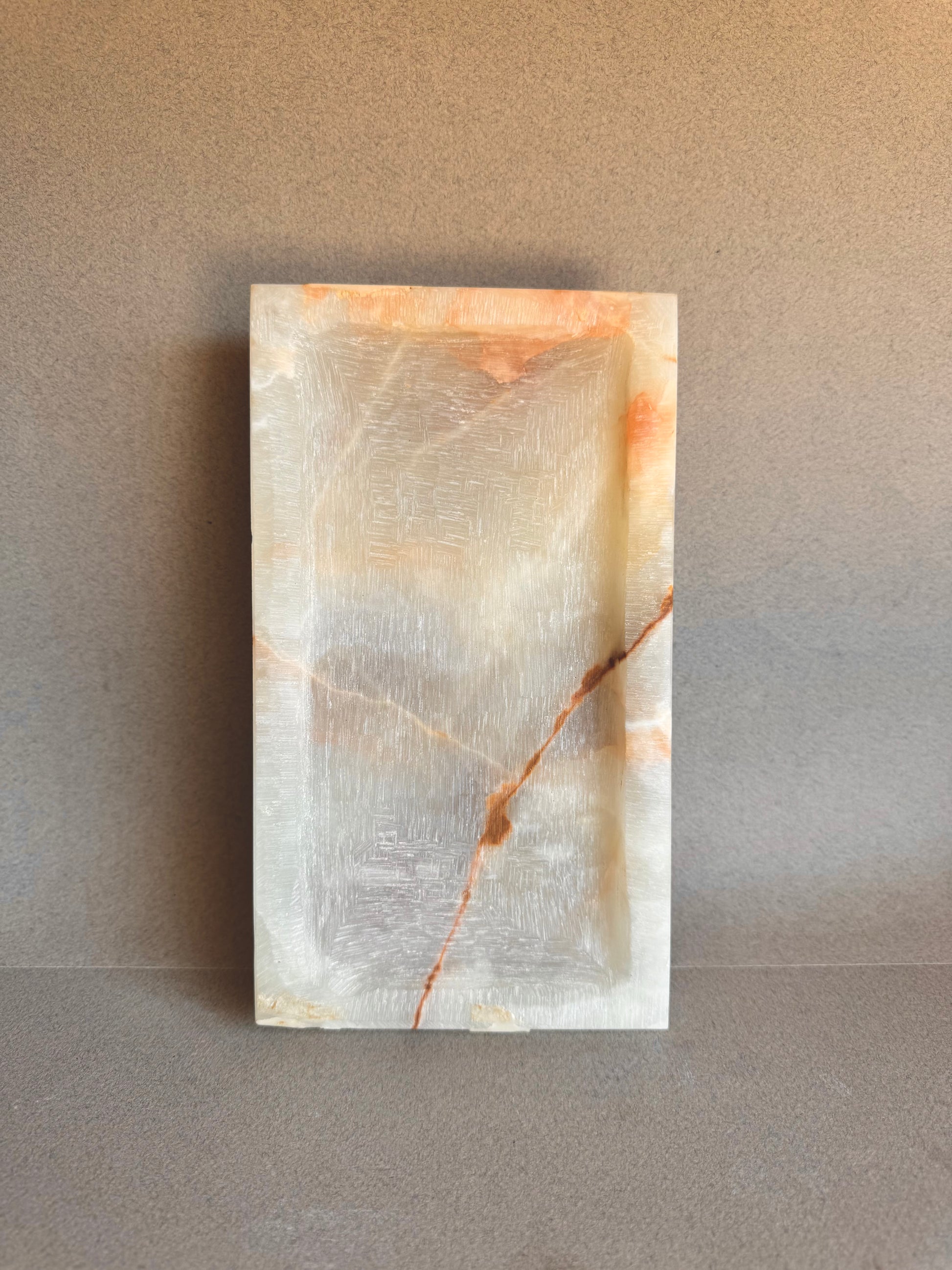 Top view of translucent ivory onyx tray with bold veining
