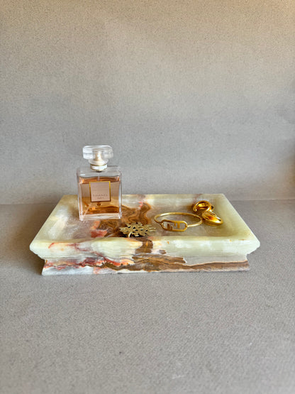 Vanity tray in onyx styled with perfume and gold jewelry, showing its multi-use versatility

