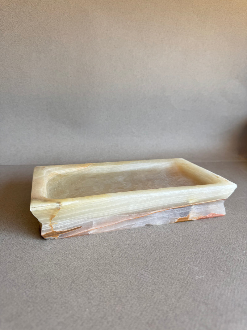 Stepped-edge onyx vanity tray in soft earth tones, styled for altar or decor use

