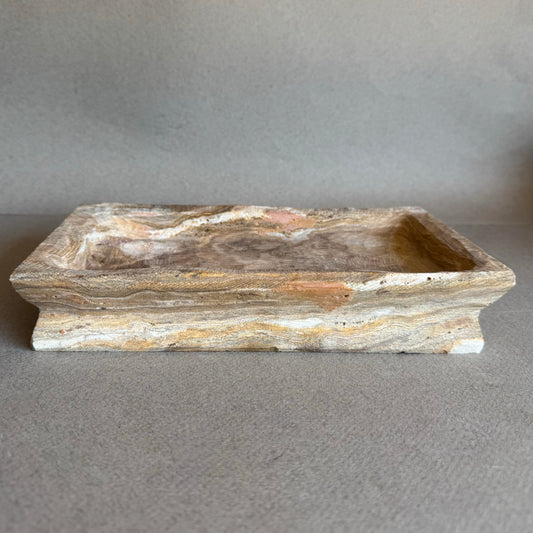 Rectangular onyx tray in taupe and rose tones on neutral background