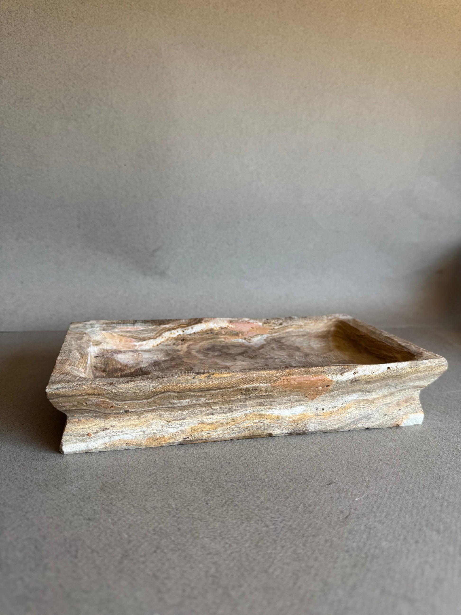Natural stone tray with stepped base in earthy brown and cream