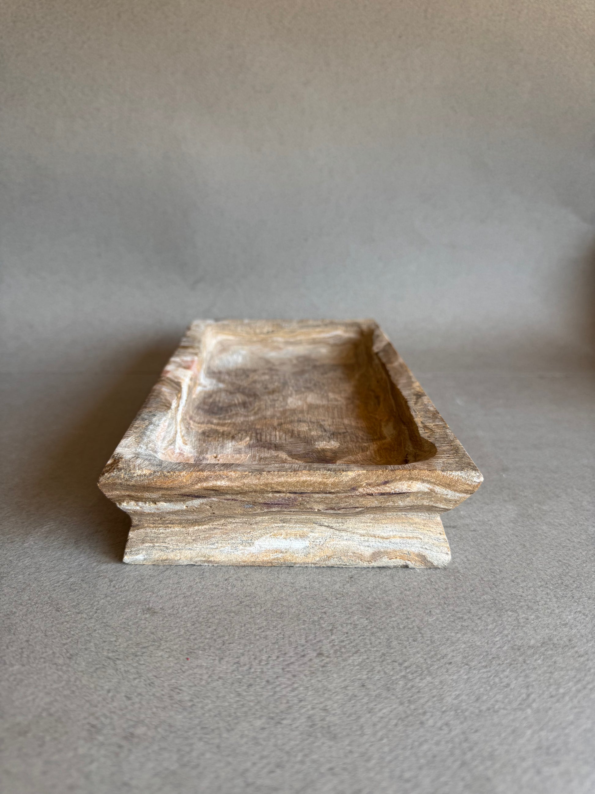 Angled side view of hand-carved onyx vanity tray