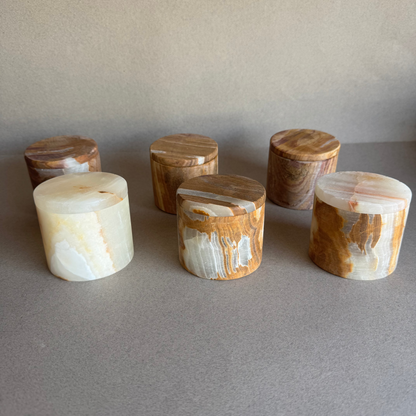 Top view of petite lidded onyx jar with warm veining and smooth matte finish