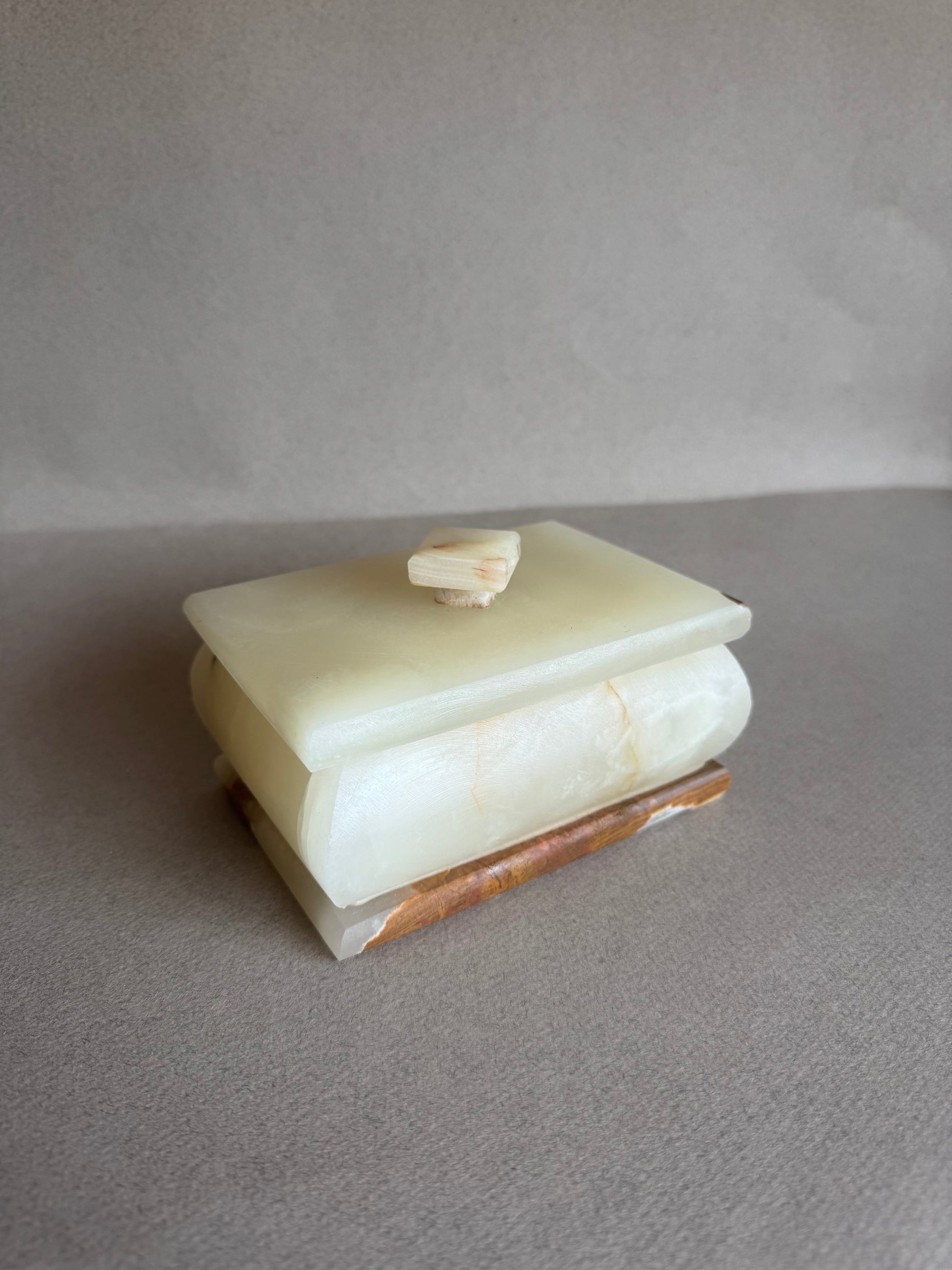 Decorative onyx box styled on shelf as sculptural home decor piece

