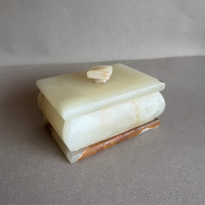 Decorative onyx box styled on shelf as sculptural home decor piece

