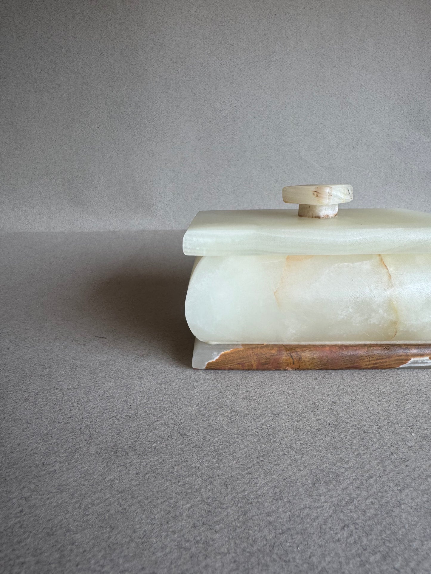 Side view of natural onyx box glowing with translucent veining in sunlight

