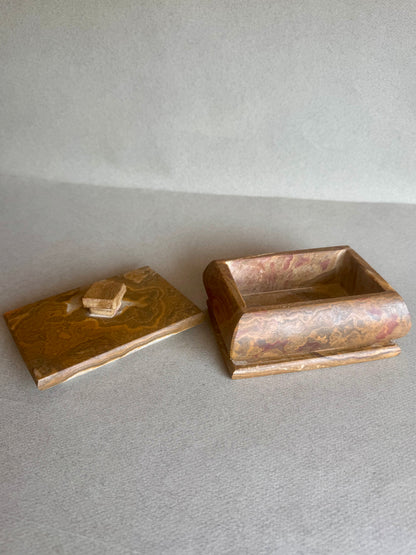 Stone container in rich ochre and rust, hand-carved and matte finished

