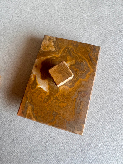 Stone container in rich ochre and rust, hand-carved and matte finished

