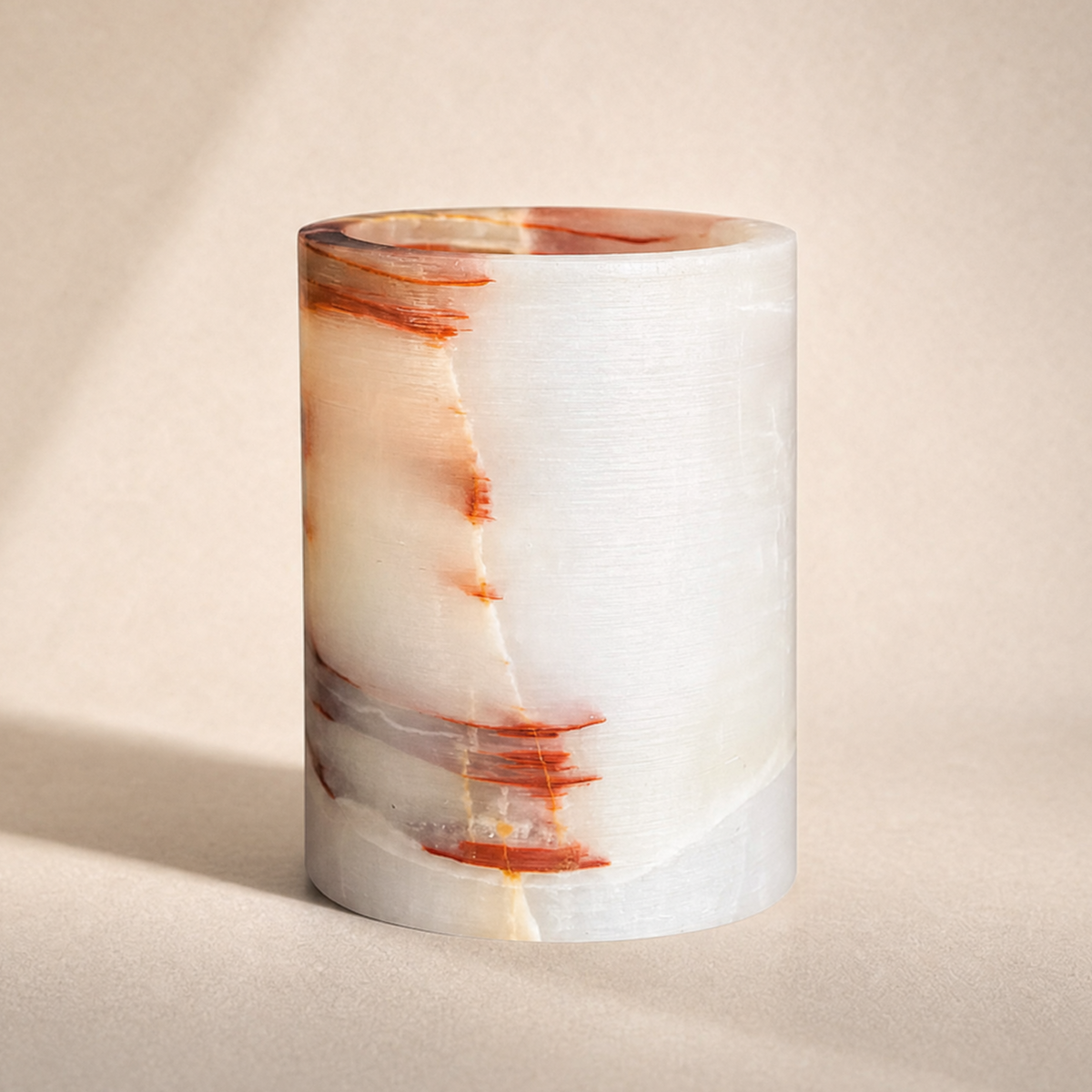 Decorative pink jar white with marbled design on a beige background