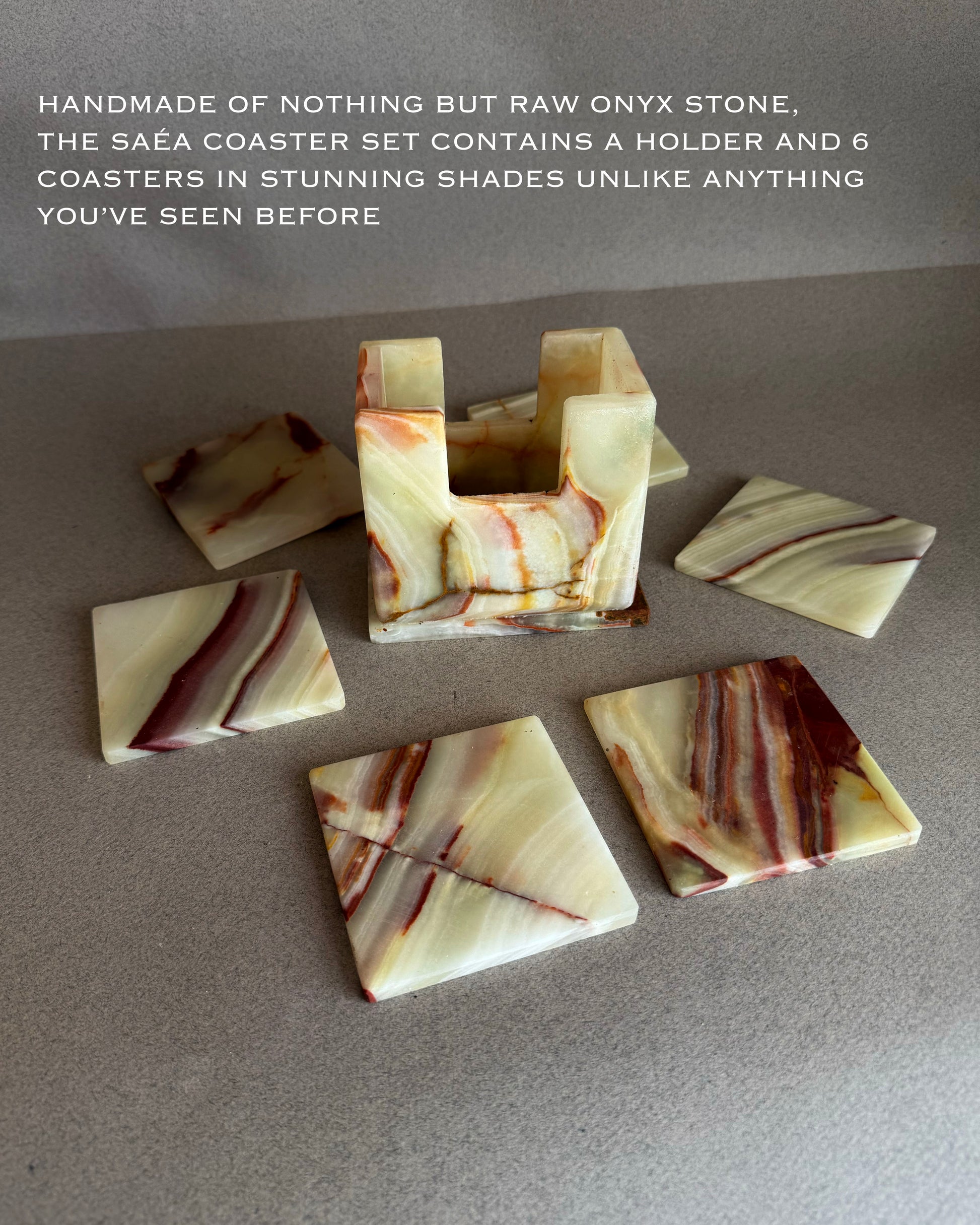 Set of raw onyx stone coasters with a holder on a gray surface.