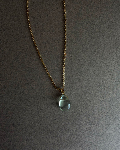 Necklace with a teardrop-shaped blue fluorite pendant on a gray background