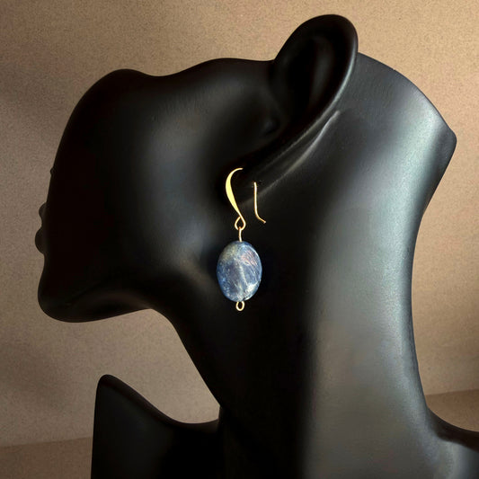 Handmade blue kyanite drop earring on matte black display, featuring natural oval blue gemstone with gold filled hook
