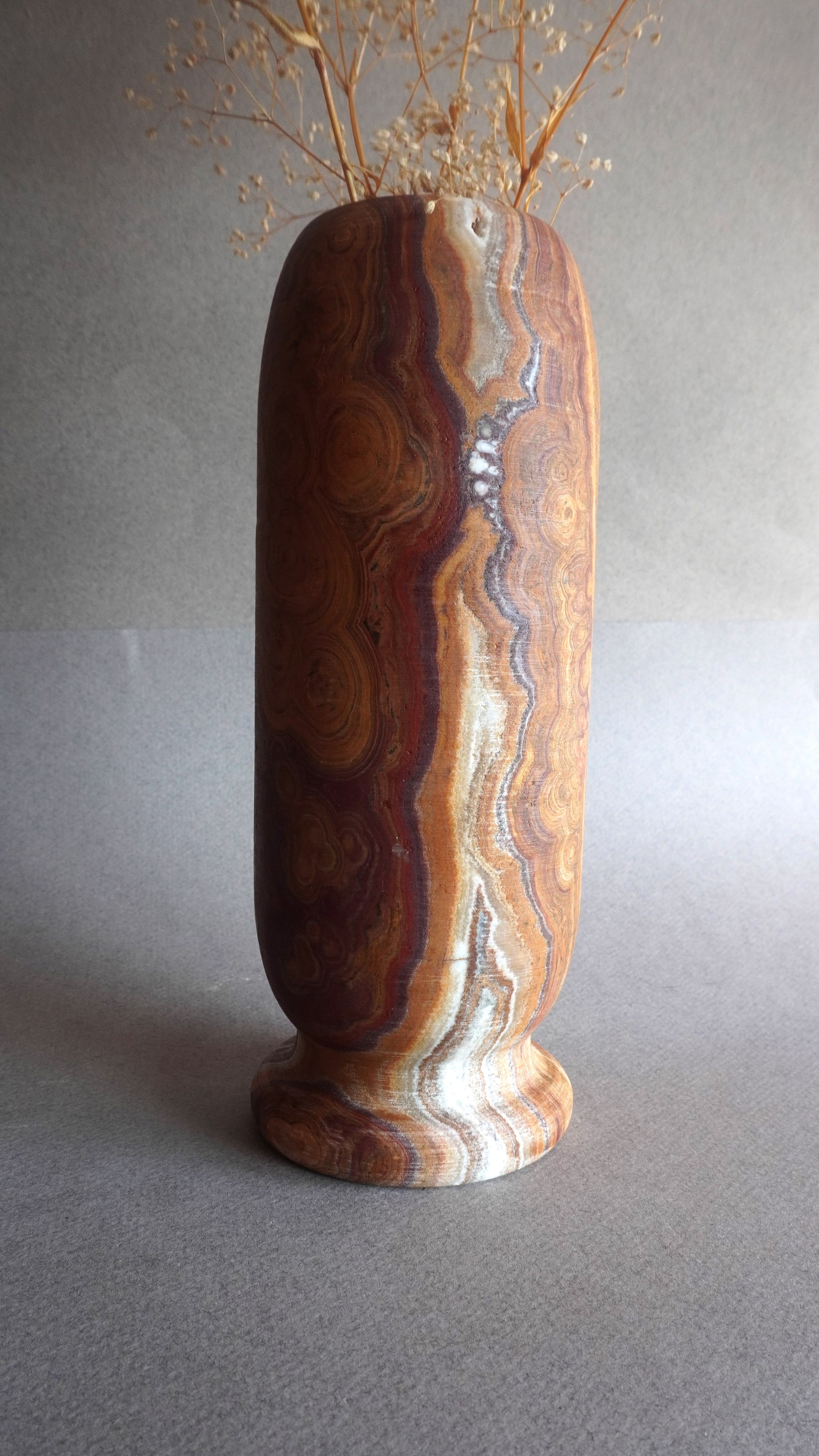 Luxury natural stone vase with earth tones, handcrafted onyx decor for wabi sabi spaces
