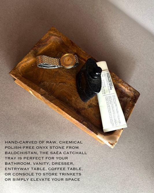 Natural onyx catchall tray with visible mineral texture and warm brown tones, sculptural stone tray for modern organic home decor  
