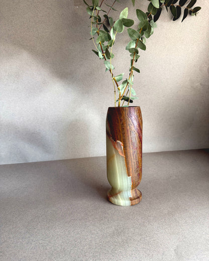 olive green brown vase with a natural finish on a neutral background