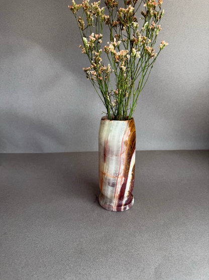 Vase with dried flowers on a gray surface and background
