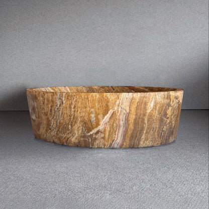Hand-carved onyx bowl featuring rich golden, chestnut, and blush veining with a raw matte finish. Sculptural and one-of-a-kind, this natural stone vessel blends organic texture with minimalist design—ideal as a fruit bowl, altar dish, or decorative centerpiece. Crafted sustainably with no polish or synthetic materials.

