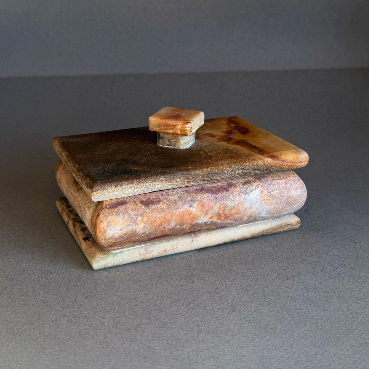Hand carved raw onyx keepsake box with square lid in rust, honey, and cream tones