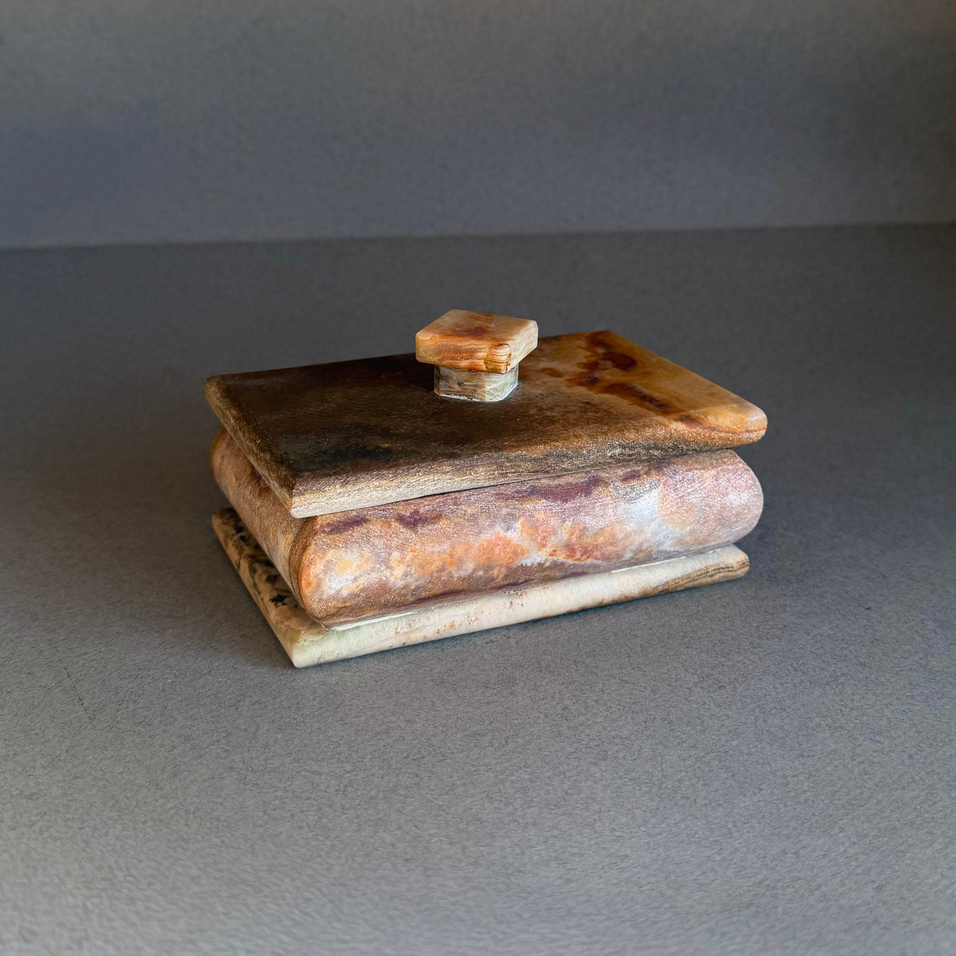 Hand carved raw onyx keepsake box with square lid in rust, honey, and cream tones