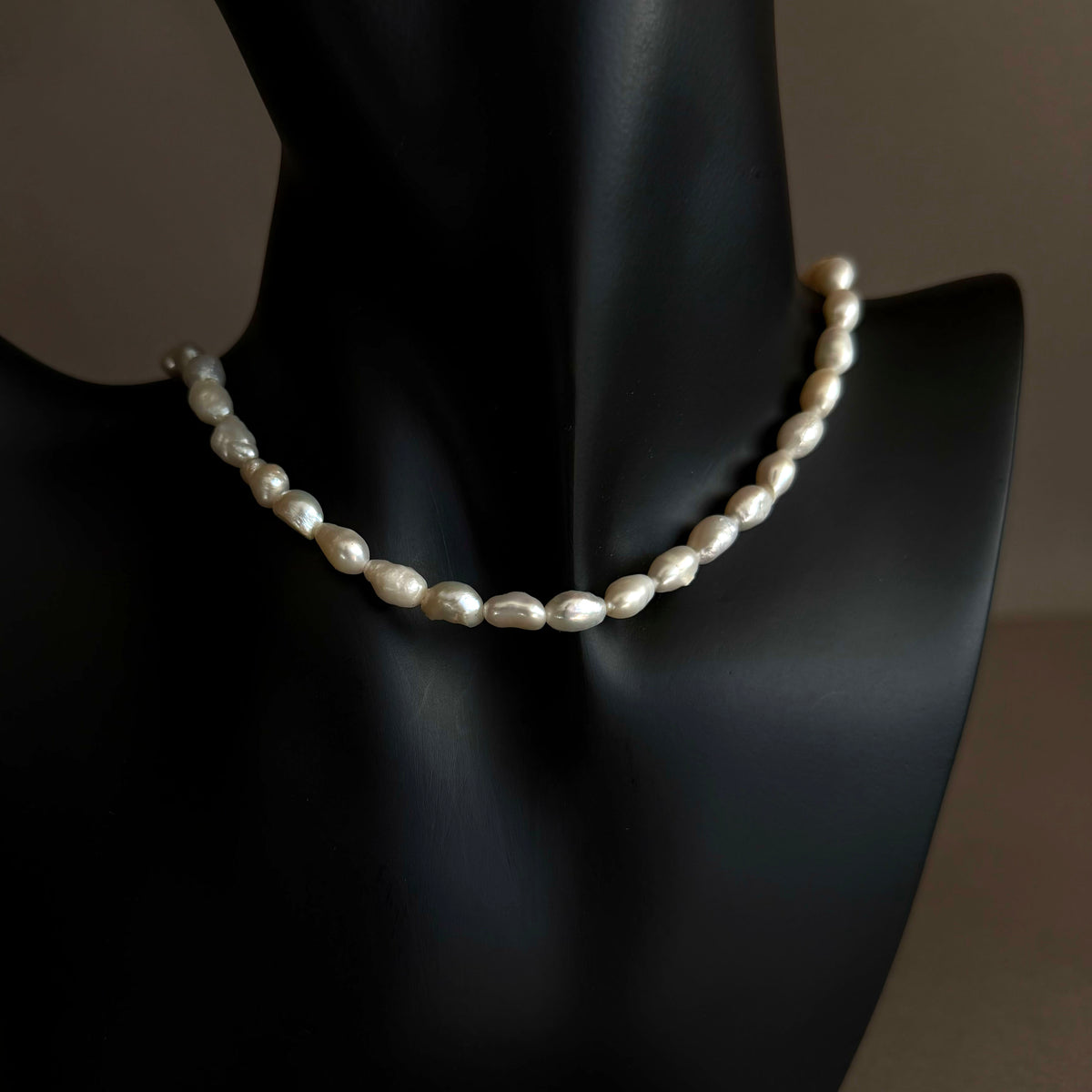 Pearl CHOKER necklace on a black mannequin against a dark background