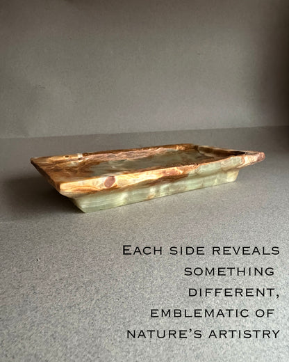 Rectangular stone tray with natural edges on a gray background