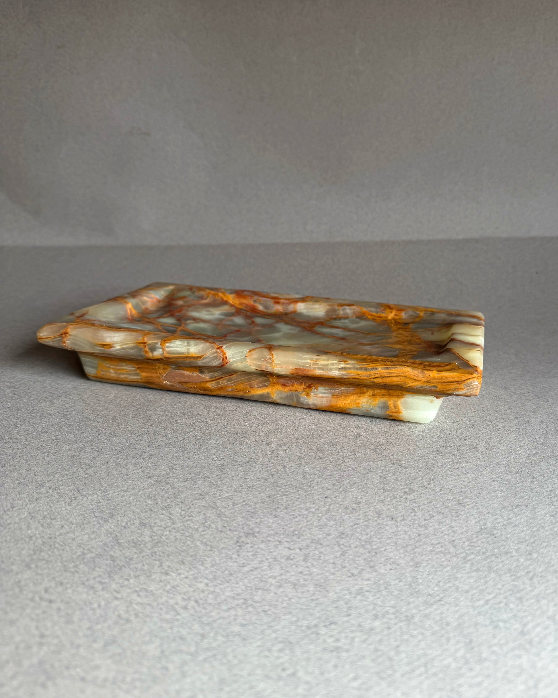 Marbled stone tray on a gray background