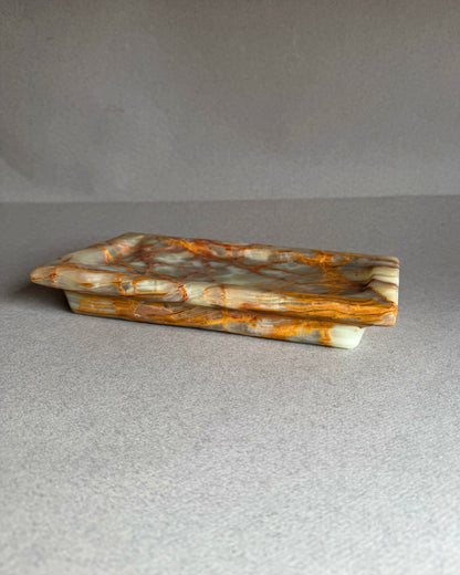 Marbled stone tray on a gray background