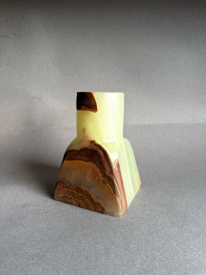 Close up of raw onyx vase highlighting organic veining, mineral layers, and natural stone texture
