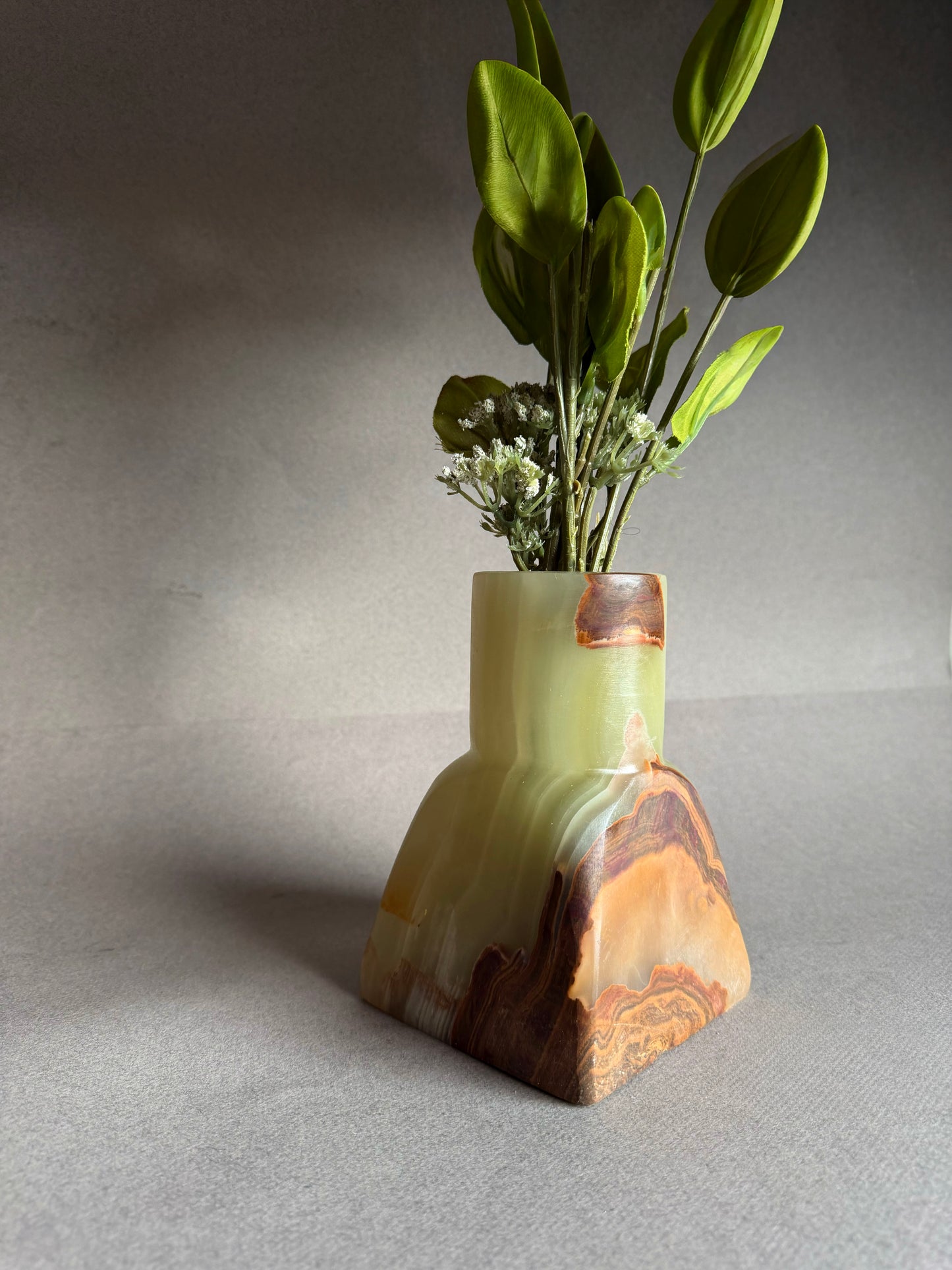 One of a kind onyx vase carved from solid stone, green, brown, and golden amber color variation
