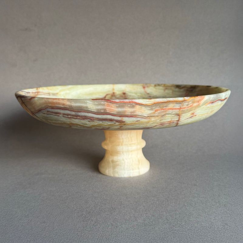 Top view of natural green onyx bowl showing moss and amber mineral patterns
