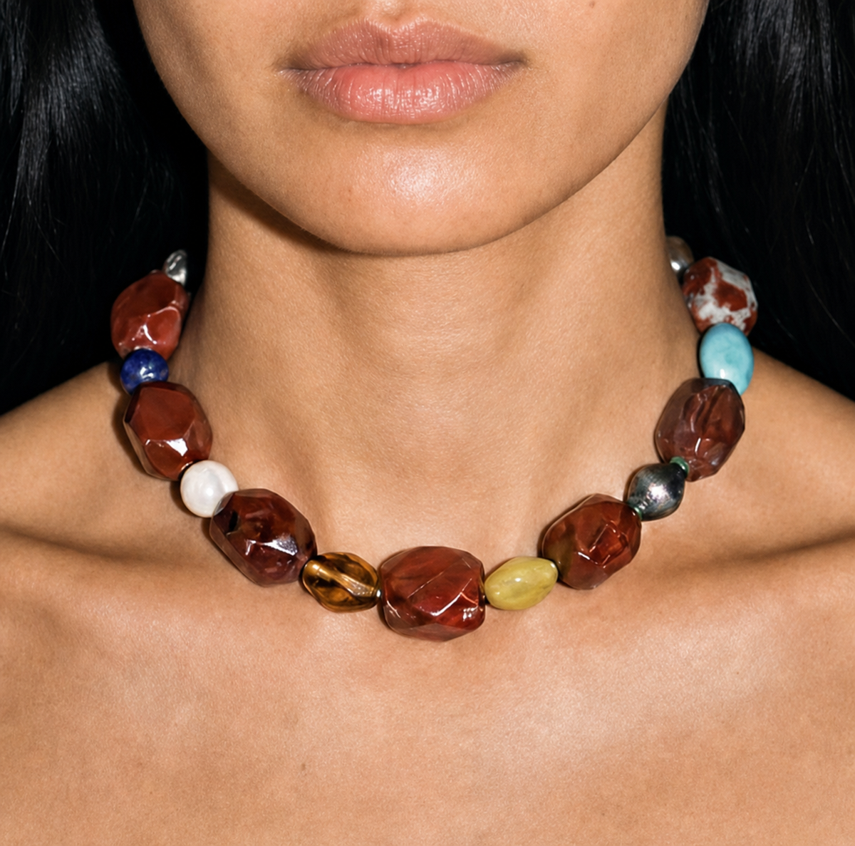 Model wearing a 16-inch vintage red jasper beaded collar necklace at the collarbone, faceted brick-red stones with turquoise and lapis accents.
