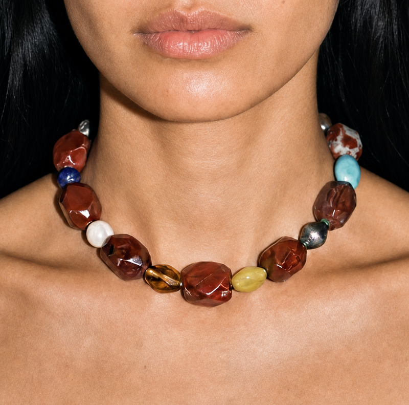 Model wearing a 16-inch vintage red jasper beaded collar necklace at the collarbone, faceted brick-red stones with turquoise and lapis accents.
