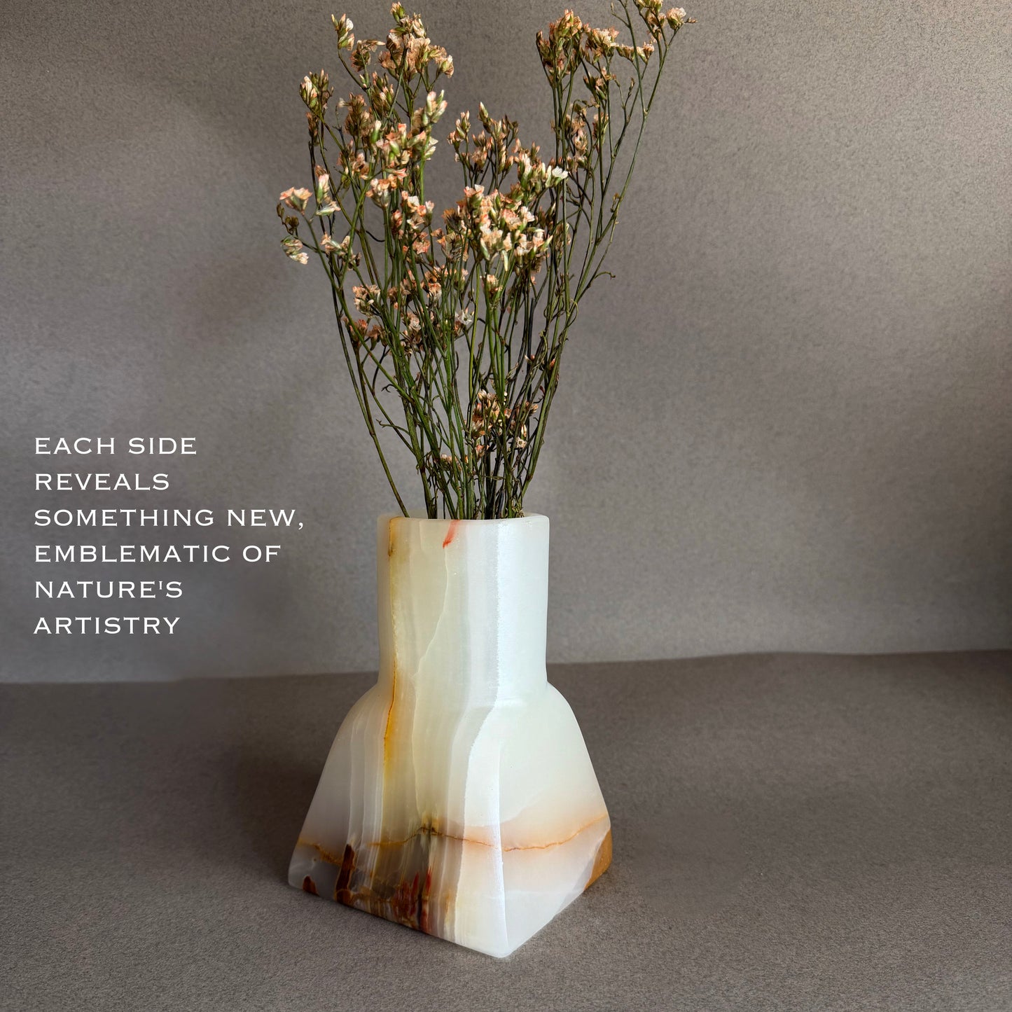 Vase with dried flowers on a gray background white onyx vase 