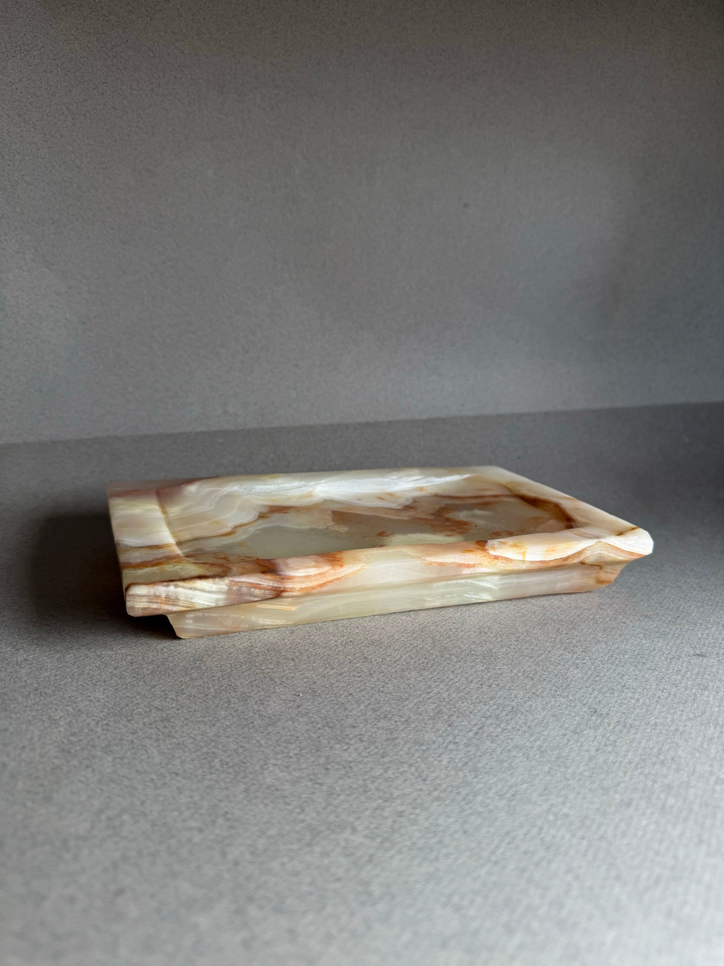 Rectangular onyx stone tray on a gray background