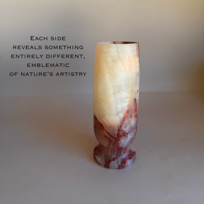 Marble-patterned vase on a plain background with text about nature's artistry.