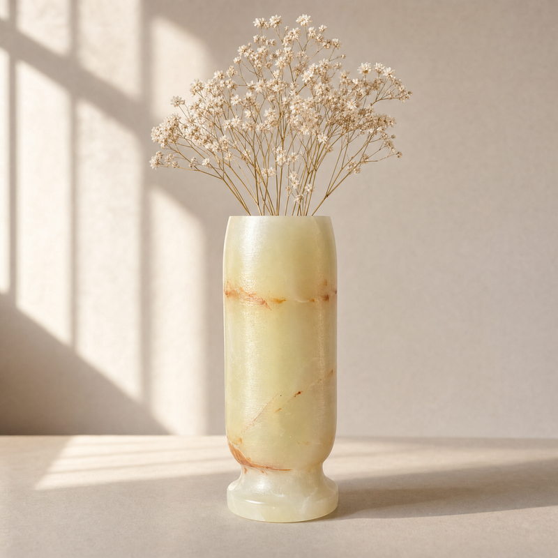 Marble-patterned light green onyx vase with dried flowers on a neutral background