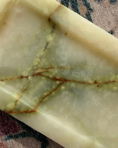 Close-up of a onyx tray with visible veins and patterns