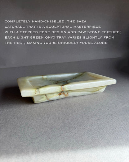 Light green onyx tray with text describing its hand-chiseled design and unique texture.