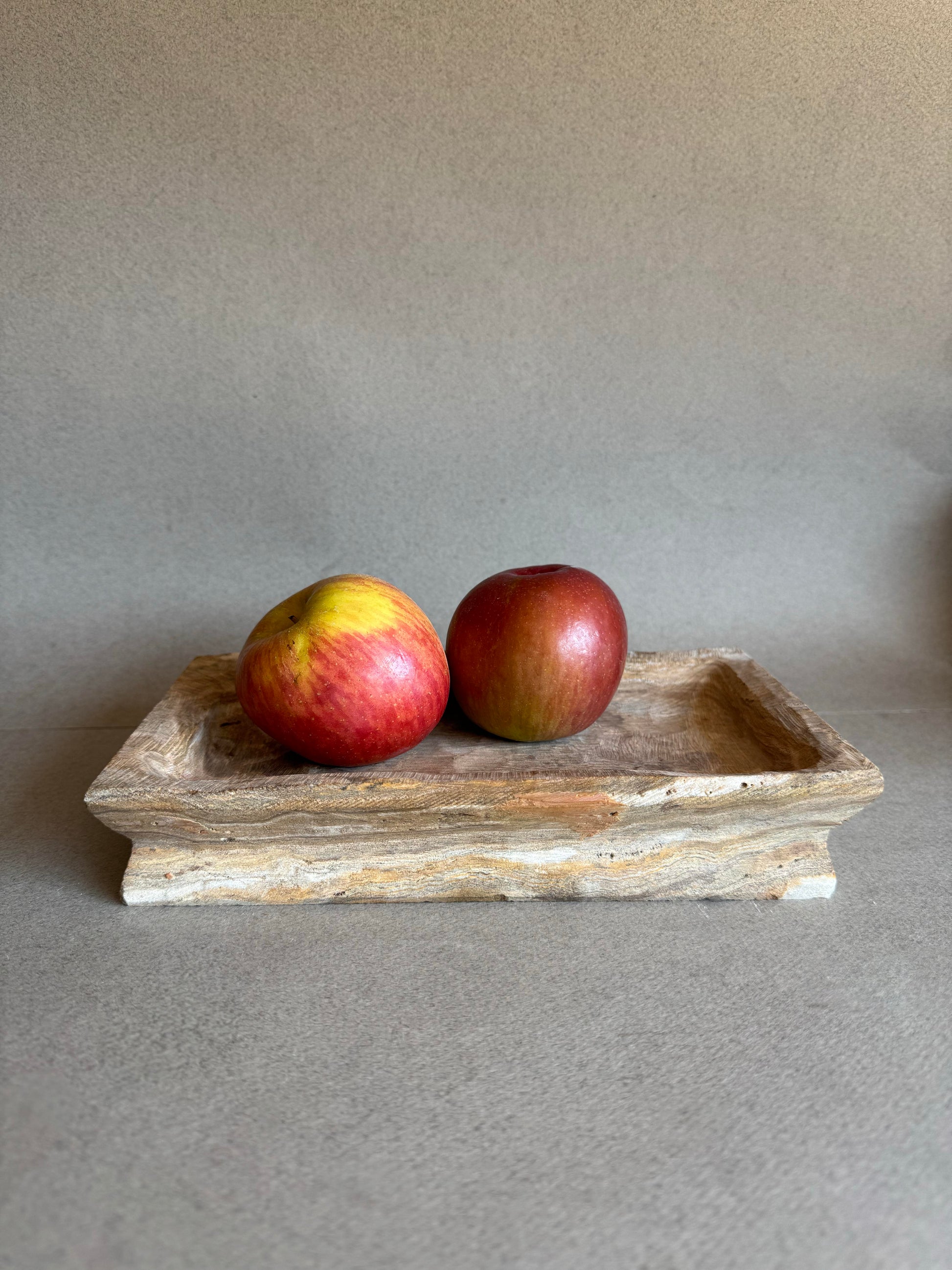 two apples on a stone fruit tray
