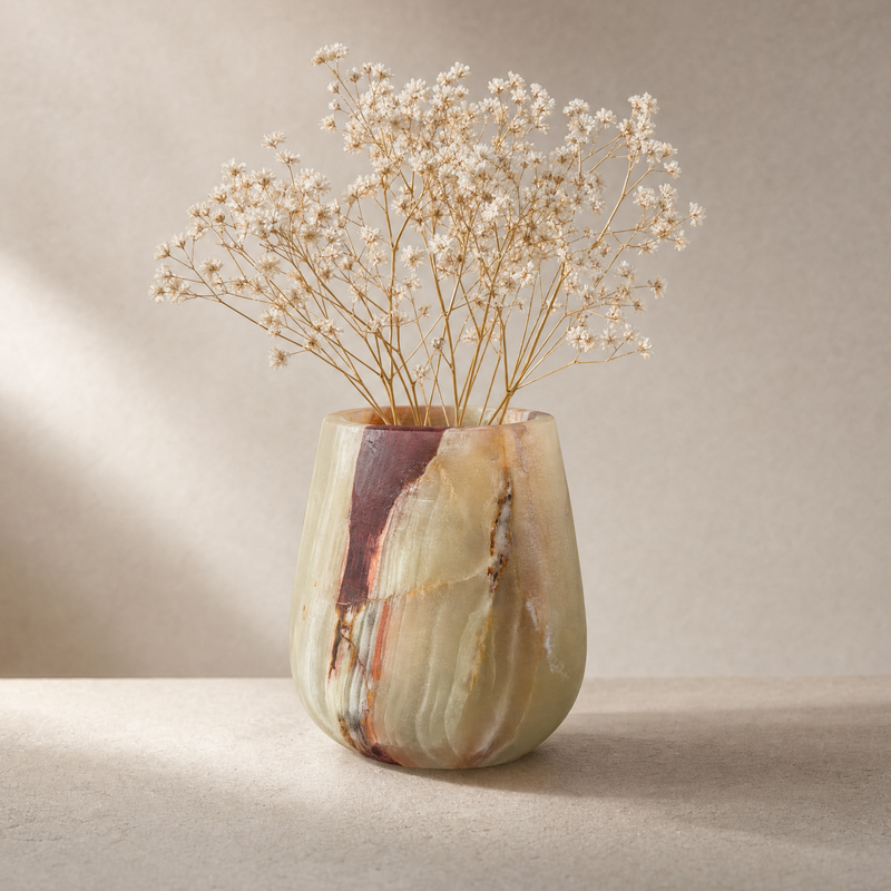 Decorative vase with dried flowers on a neutral background