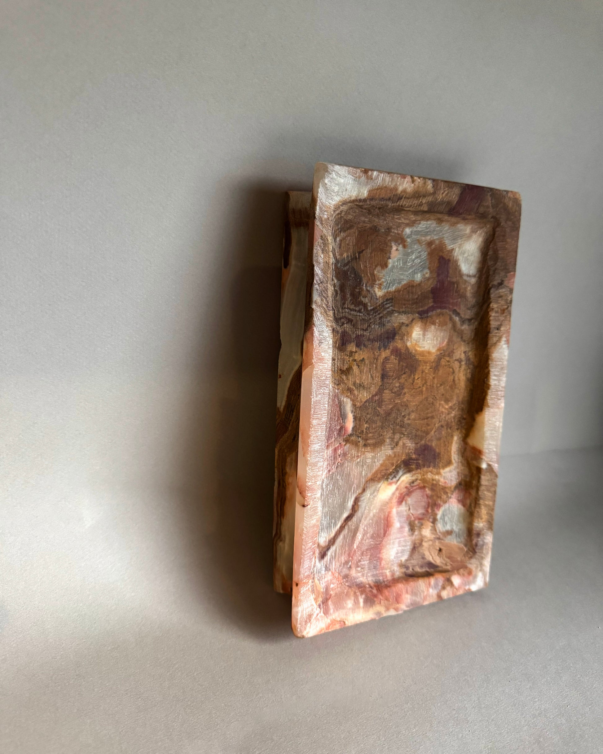 Decorative stone block with natural patterns on a gray background