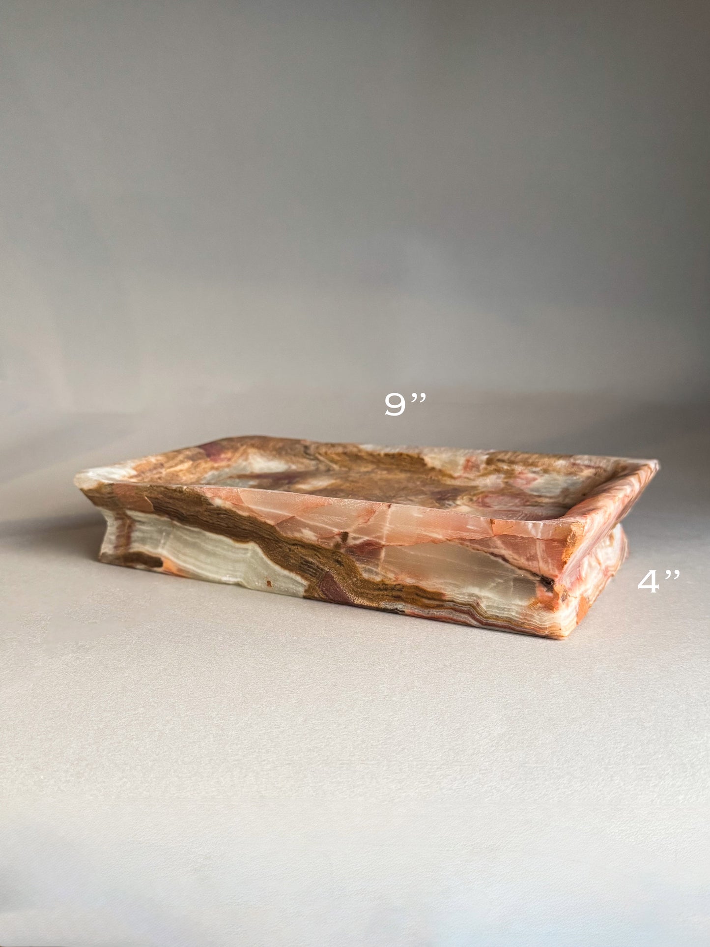 Decorative stone tray with measurements on a gray background