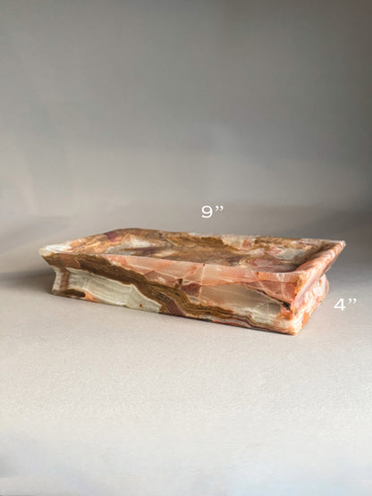 Decorative stone tray with measurements on a gray background