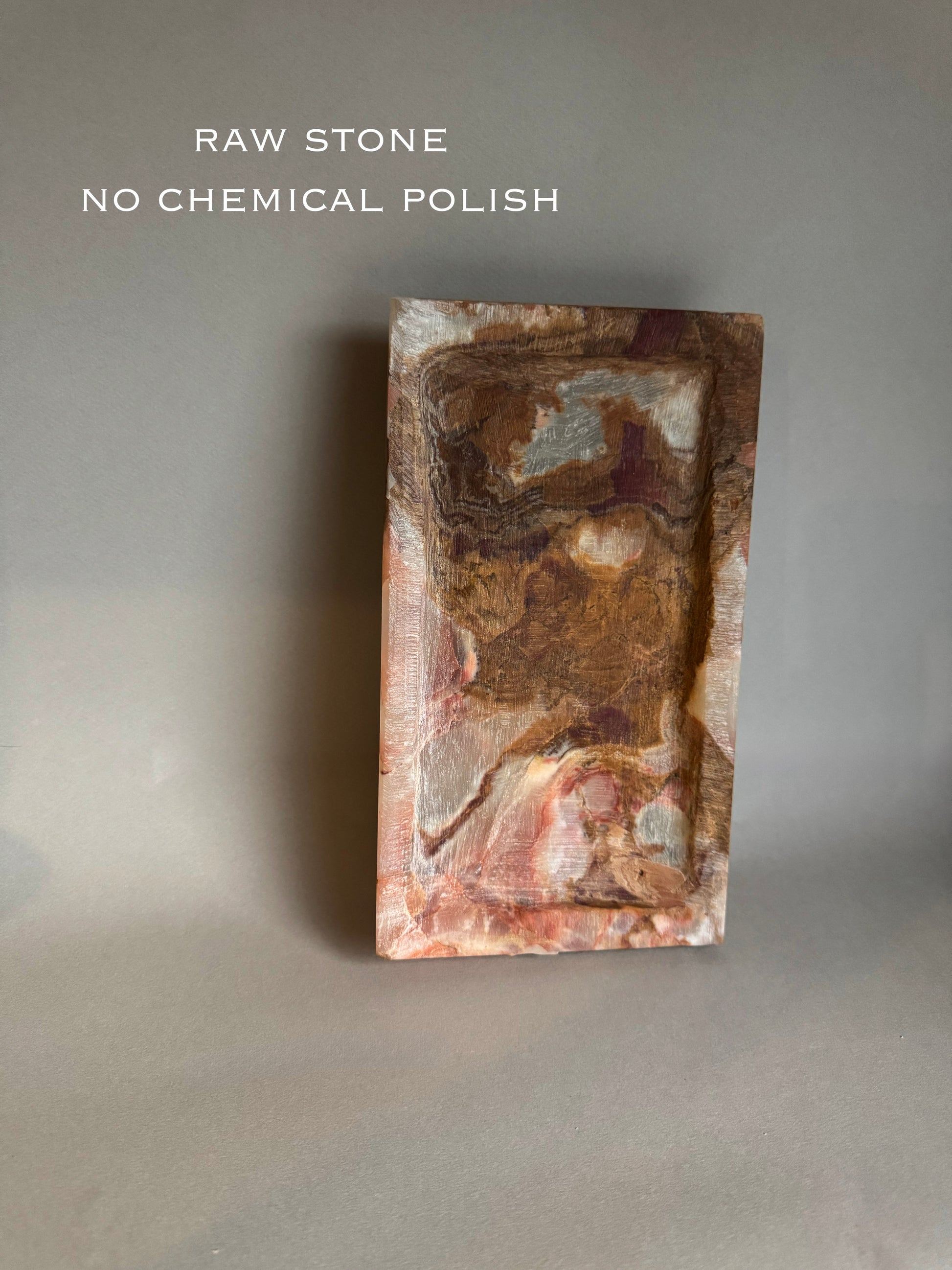 Raw stone block with natural texture on a gray background, labeled 'Raw Stone No Chemical Polish'.