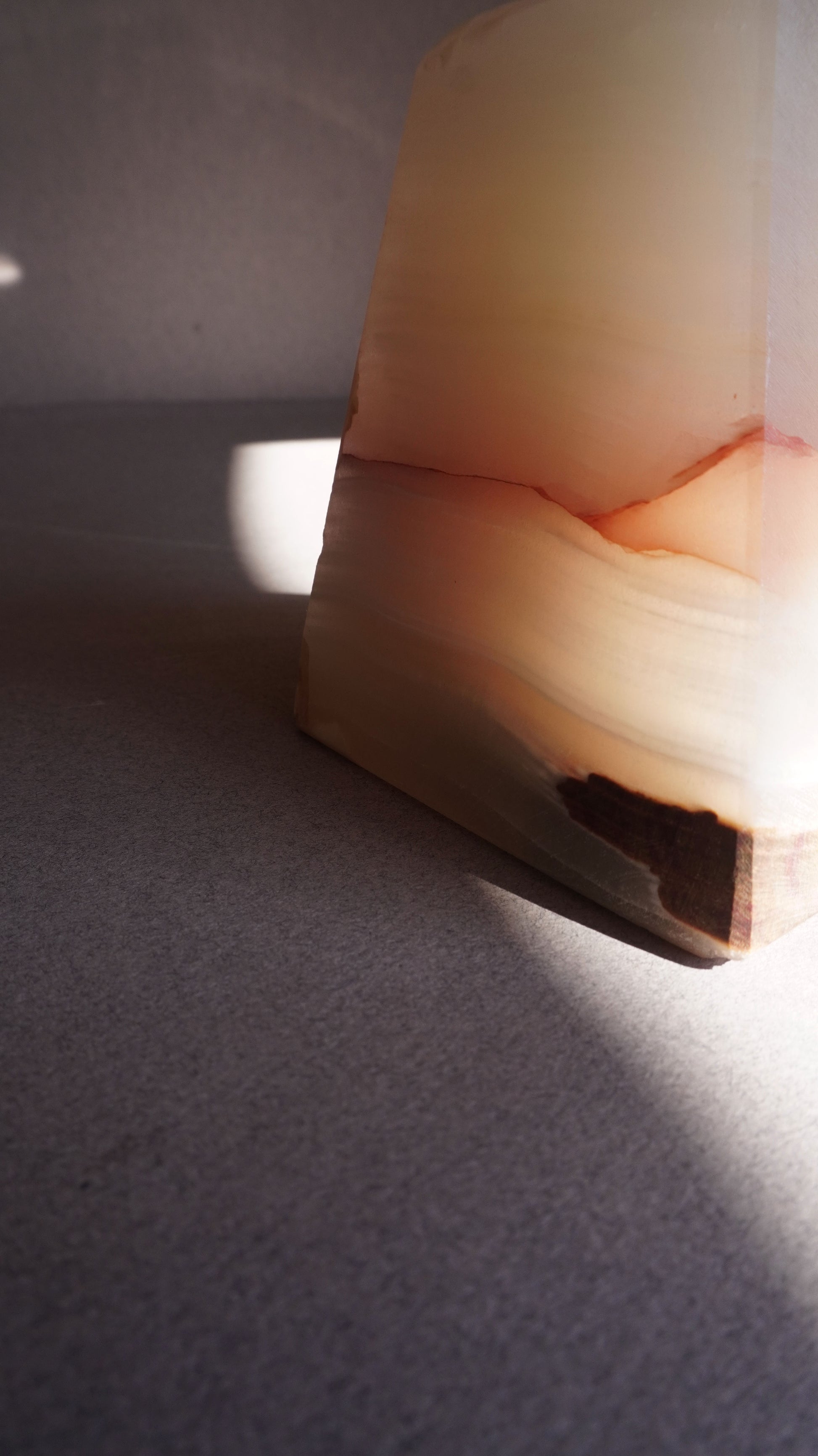 Close-up of a onyx block with a cutout on a textured surface